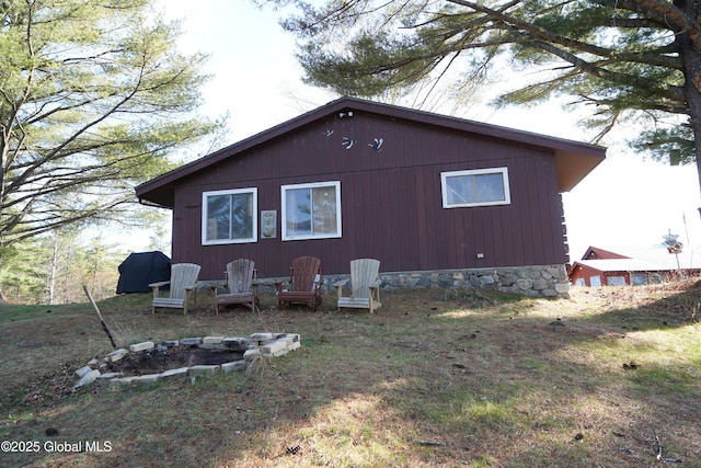 back of house featuring a fire pit