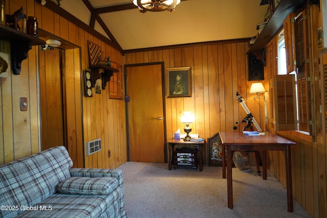 carpeted living room with wooden walls and lofted ceiling with beams