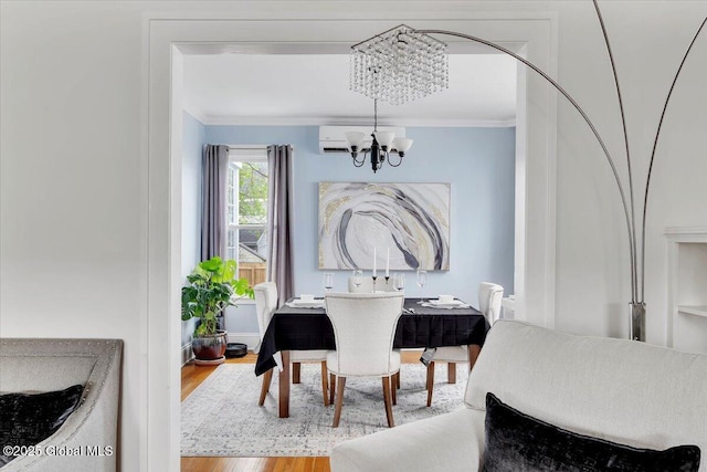 dining area featuring a chandelier, wood finished floors, and ornamental molding