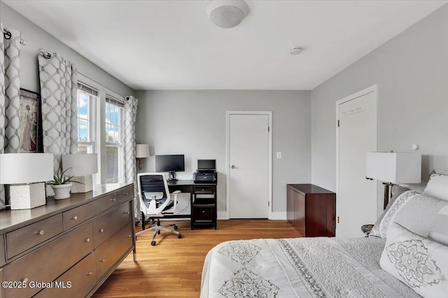 bedroom featuring baseboards and light wood-style flooring
