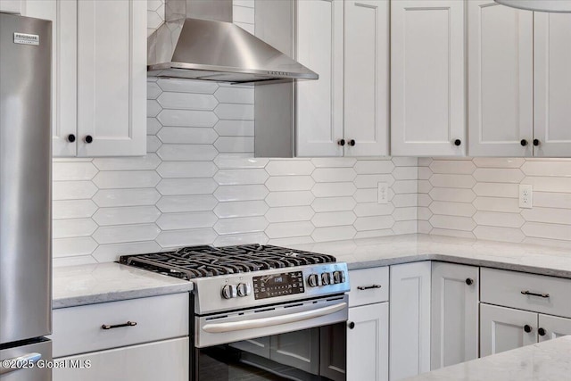 53 Wardley Cir, Colonie, NY 12047 - kitchen featuring appliances with stainless steel finishes, wall chimney range hood, backsplash, white cabinetry, and light stone countertops
