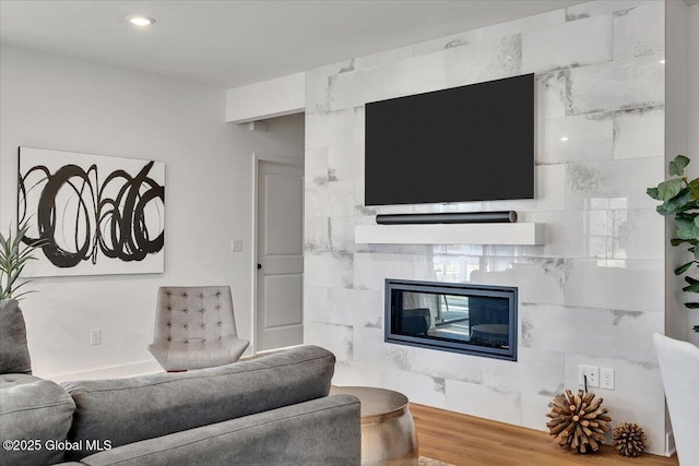 53 Wardley Cir, Colonie, NY 12047 - living area featuring a glass covered fireplace and wood finished floors
