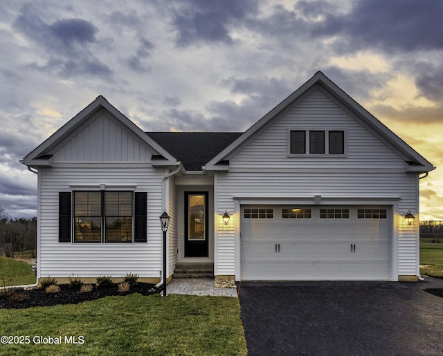 7 Magnolia Dr, Halfmoon, NY 12065 - view of front facade featuring a lawn, driveway, and board and batten siding