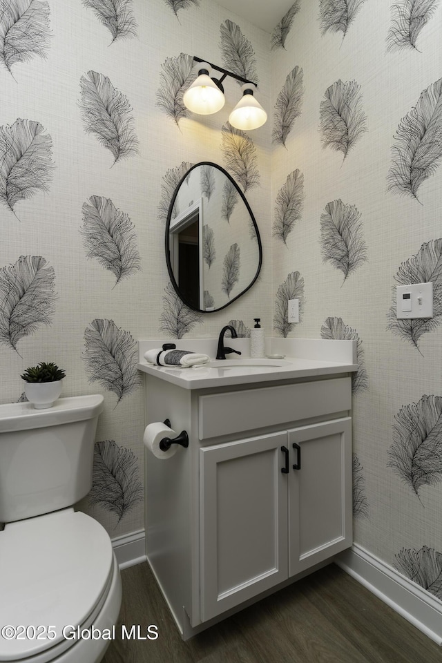 7 Magnolia Dr, Halfmoon, NY 12065 - bathroom with wallpapered walls, baseboards, toilet, vanity, and wood finished floors