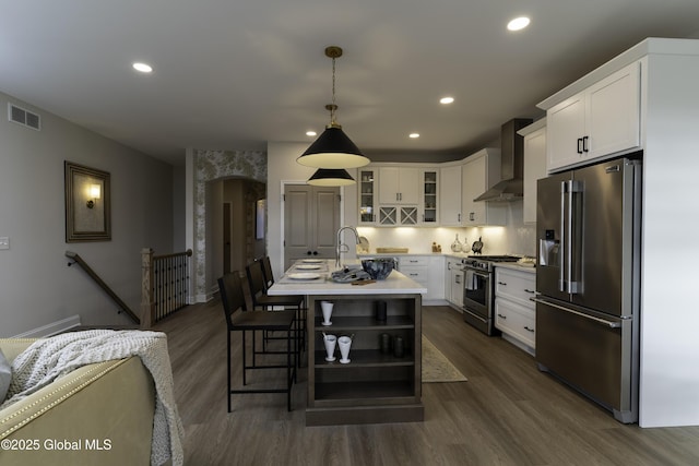 7 Magnolia Dr, Halfmoon, NY 12065 - kitchen featuring light countertops, premium appliances, dark wood-style flooring, visible vents, and wall chimney range hood