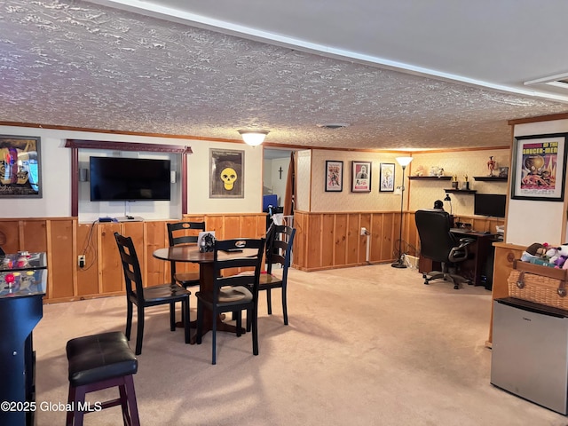 dining room featuring crown molding, a textured ceiling, wainscoting, and carpet floors