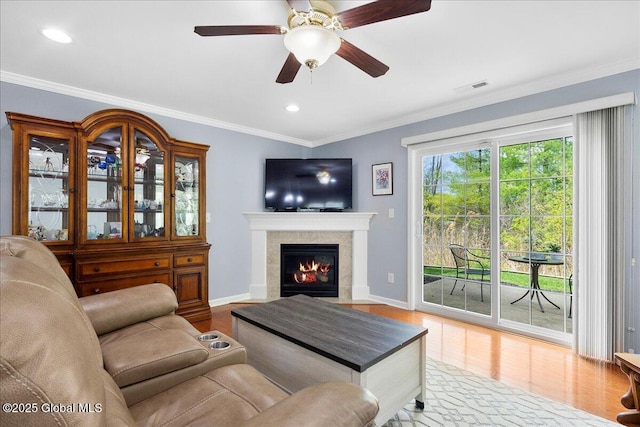 51 Treasures Pl, Queensbury, NY 12804 - living room with ornamental molding, baseboards, a tiled fireplace, and wood finished floors