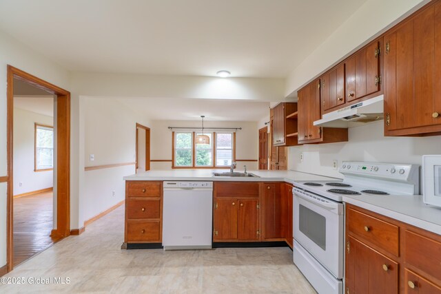 27 Patricia Ln, Saratoga Springs, Inside, NY 12866 - kitchen featuring white appliances, under cabinet range hood, brown cabinetry, and light countertops