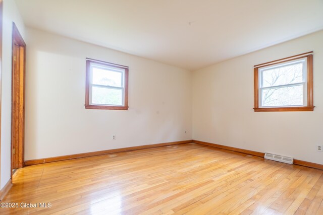 27 Patricia Ln, Saratoga Springs, Inside, NY 12866 - empty room with healthy amount of natural light, light wood-style floors, and baseboards