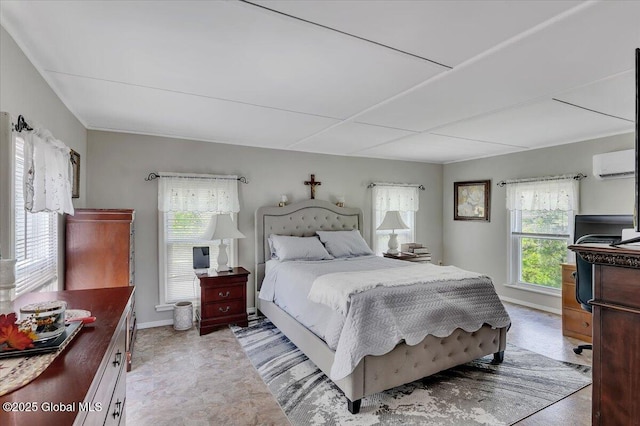 bedroom featuring baseboards and a wall unit AC