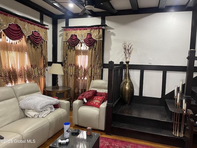 interior space featuring coffered ceiling, beam ceiling, a ceiling fan, and wood finished floors