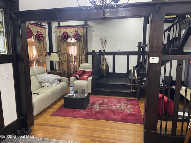 living room with a notable chandelier and wood finished floors