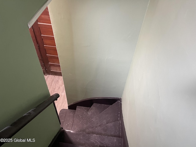 staircase with wood finished floors