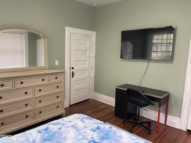 bedroom featuring baseboards and dark wood-style floors