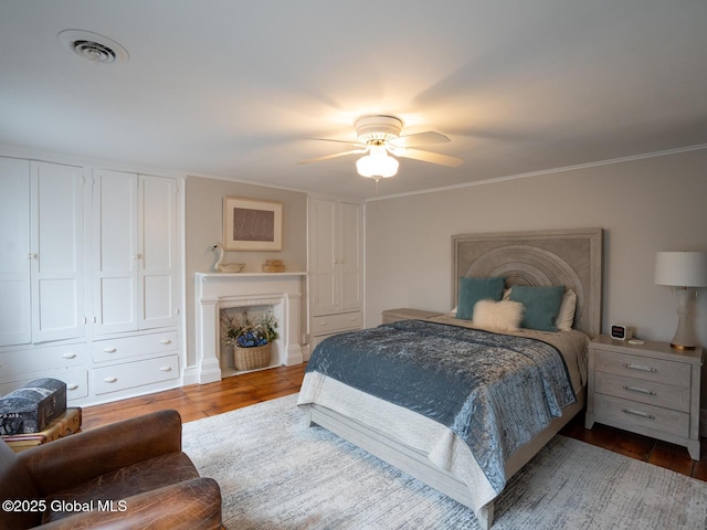 33 Broadway, Rensselaer, NY 12144 - bedroom featuring a fireplace, wood finished floors, crown molding, and ceiling fan
