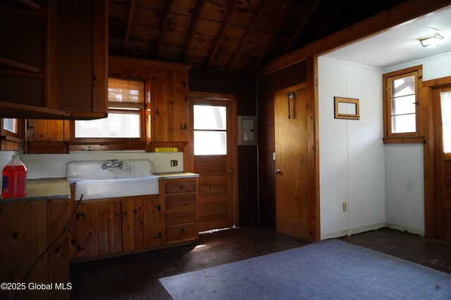 6222 Rte 9n, Hadley, NY 12835 - kitchen with a sink, brown cabinetry, and vaulted ceiling