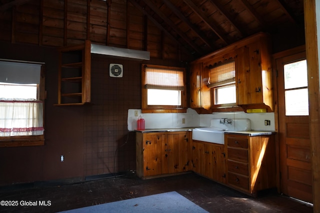 6222 Rte 9n, Hadley, NY 12835 - kitchen featuring a sink, lofted ceiling, light countertops, and brown cabinetry