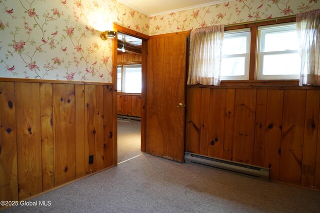6222 Rte 9n, Hadley, NY 12835 - empty room with a baseboard radiator, wallpapered walls, a wainscoted wall, wood walls, and crown molding