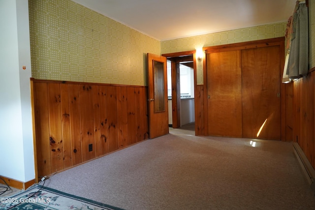 6222 Rte 9n, Hadley, NY 12835 - unfurnished bedroom with wood walls, wainscoting, a baseboard radiator, carpet, and wallpapered walls