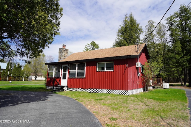 6222 Rte 9n, Hadley, NY 12835 - view of front of home with entry steps, a chimney, board and batten siding, a front yard, and crawl space