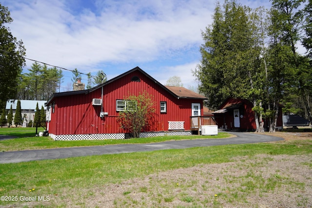 6222 Rte 9n, Hadley, NY 12835 - view of side of property featuring a lawn, a chimney, a wall mounted air conditioner, and board and batten siding