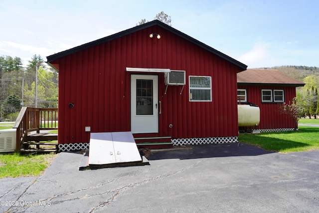6222 Rte 9n, Hadley, NY 12835 - view of outdoor structure featuring entry steps, oil tank, and a wall unit AC
