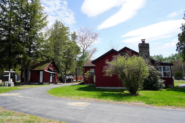 6222 Rte 9n, Hadley, NY 12835 - view of front of property with board and batten siding, a chimney, and a front yard