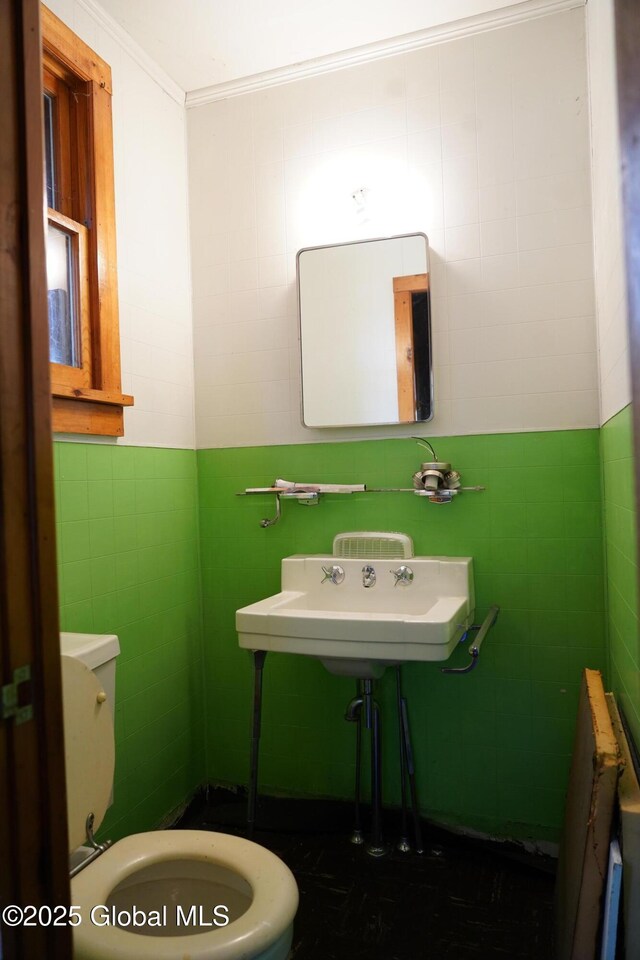 6222 Rte 9n, Hadley, NY 12835 - half bathroom with tile walls, crown molding, and toilet