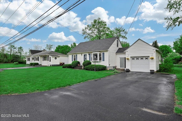 view of front of home with a garage, asphalt driveway, and a front lawn
