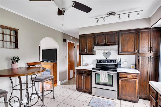 kitchen with stainless steel electric range, under cabinet range hood, a ceiling fan, light countertops, and light tile patterned floors