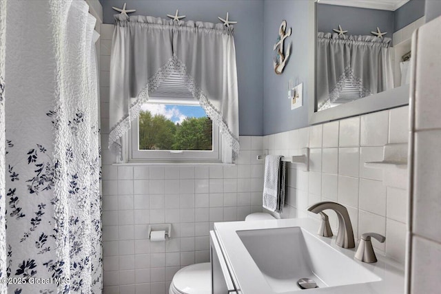 bathroom featuring toilet, tile walls, a shower with shower curtain, and vanity