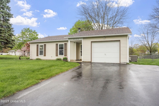 ranch-style house featuring a garage, driveway, and central AC unit