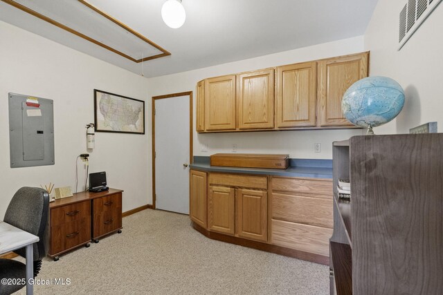 office space featuring electric panel, attic access, light carpet, and baseboards