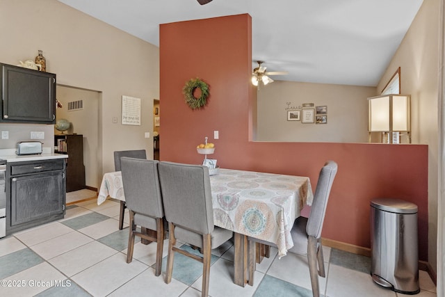 dining space with a ceiling fan and vaulted ceiling