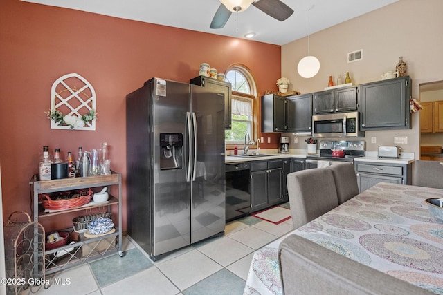 kitchen with stainless steel appliances, a sink, light countertops, a ceiling fan, and pendant lighting
