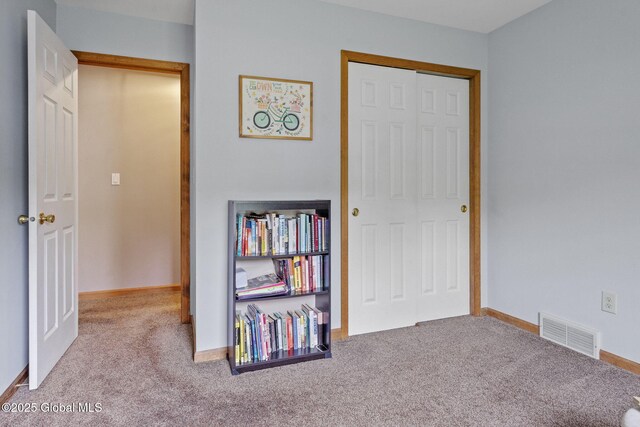 unfurnished bedroom featuring carpet floors, a closet, and baseboards