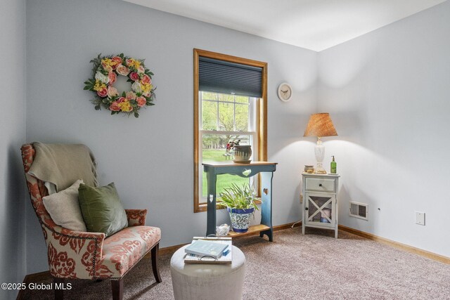 sitting room with carpet floors and baseboards