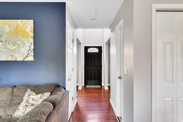 entrance foyer featuring dark wood finished floors and baseboards