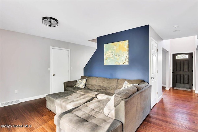 living area with wood finished floors and baseboards