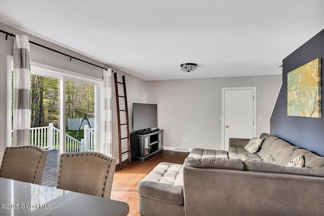 living room featuring wood finished floors and baseboards