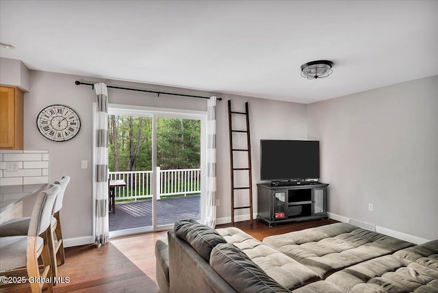 living room featuring baseboards and wood finished floors