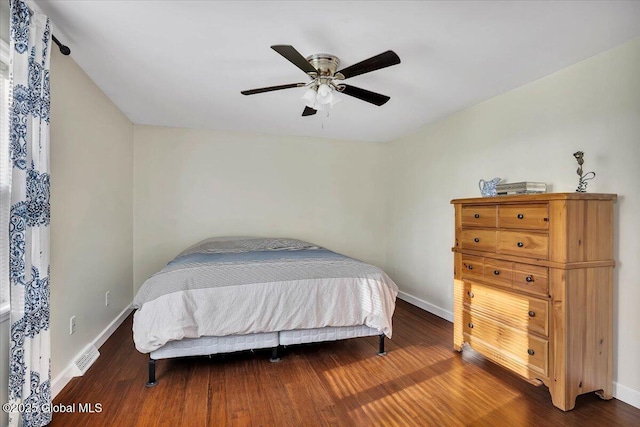 bedroom with wood finished floors and baseboards