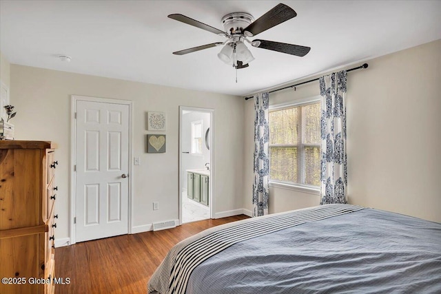 bedroom featuring wood finished floors, baseboards, connected bathroom, and a ceiling fan