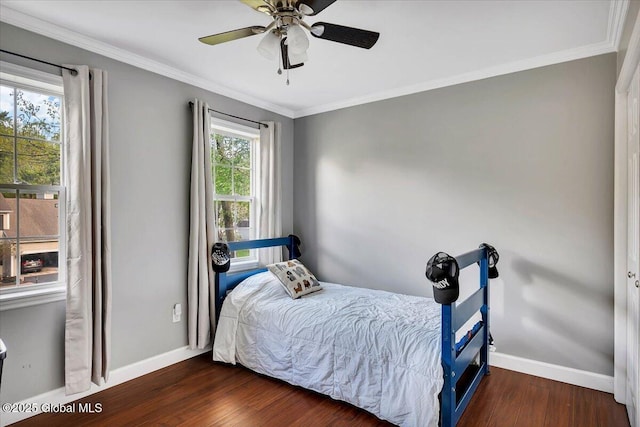 bedroom with baseboards, wood finished floors, crown molding, and ceiling fan