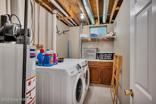 clothes washing area featuring gas water heater and independent washer and dryer