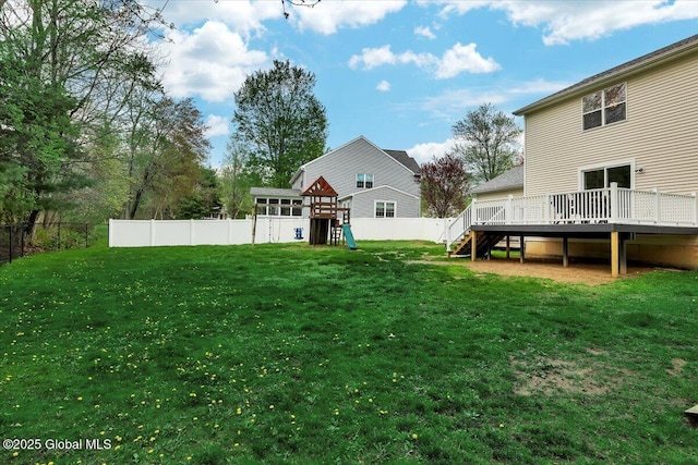 view of yard featuring a playground, a wooden deck, and stairway