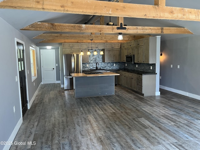 kitchen featuring freestanding refrigerator, backsplash, baseboards, and beam ceiling