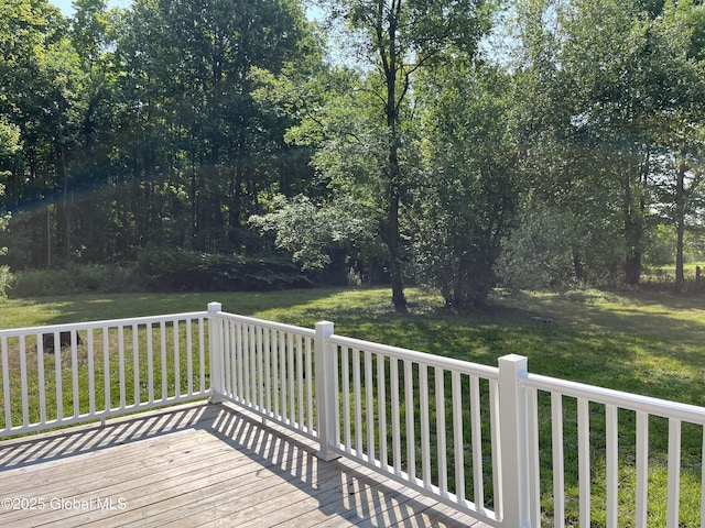 wooden terrace featuring a yard