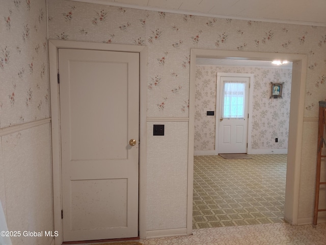 hallway with wallpapered walls