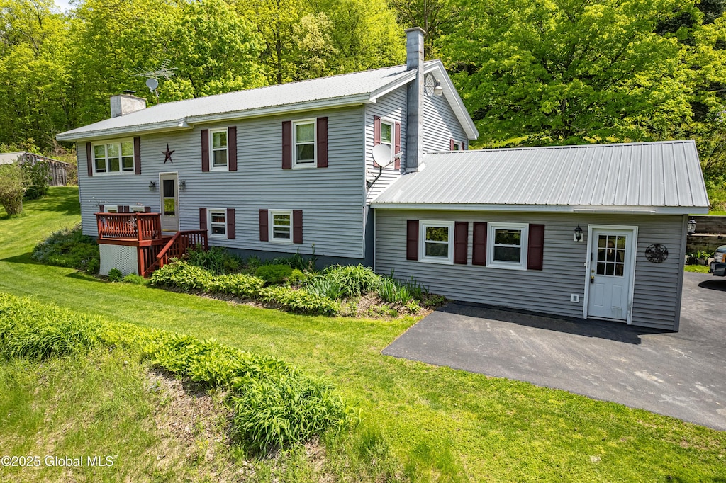 3180 Coach Rd, Hartford, NY 12809 - back of property featuring a chimney, metal roof, a patio, and a yard
